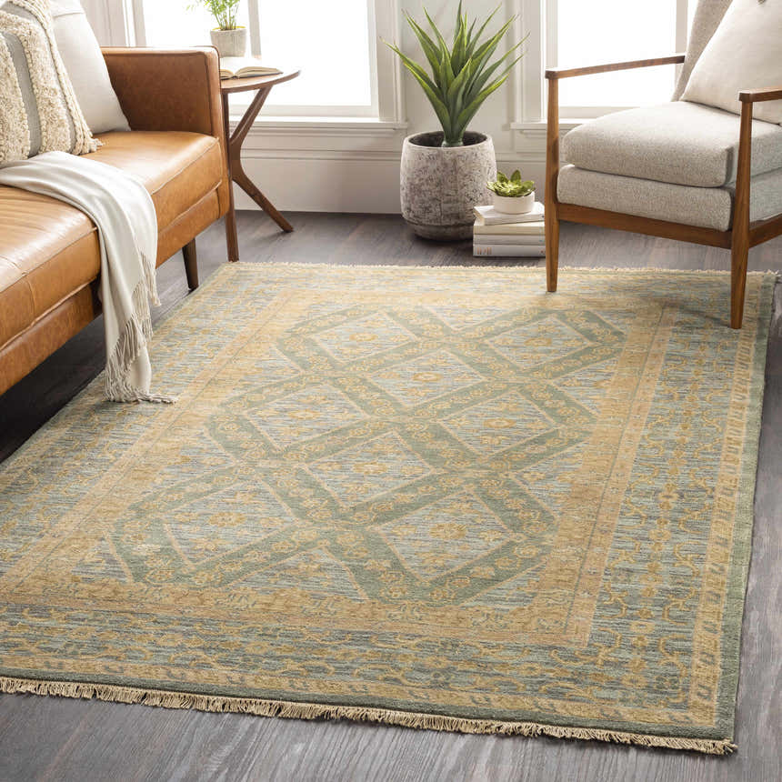 Styled living room scene with a beige, denim, and sage Fogelsville Area Rug with a traditional diamond pattern. Roomscene-Rectangle
