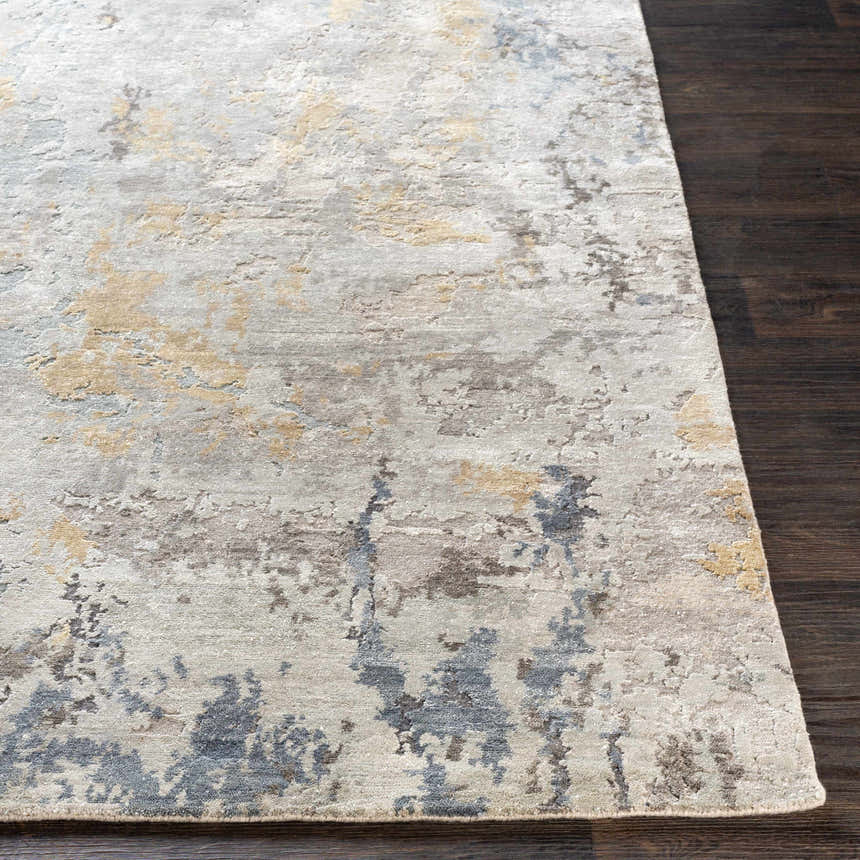 Close up of the Follansbee Area Rug. Beige, charcoal, gray, and sage abstract pattern. Hand knotted viscose rug. Front
