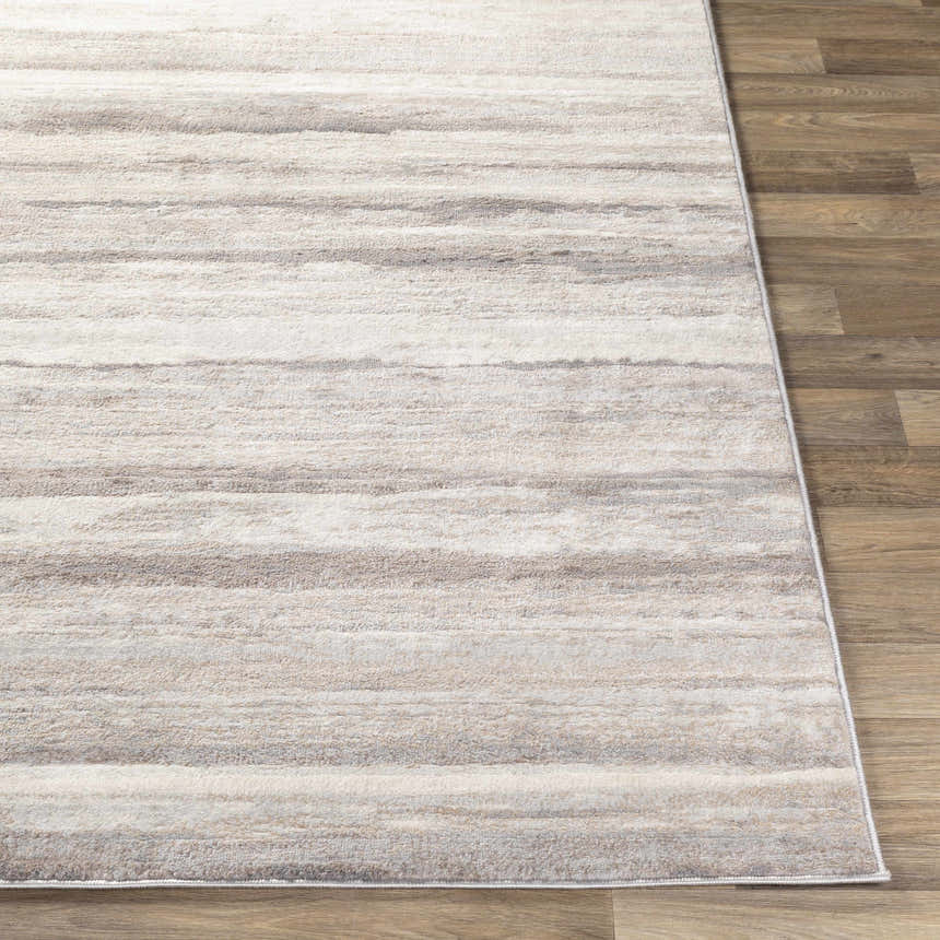 Close-up of Fombell Abstract Striped Area Rug. Charcoal, gray, tan, and white stripes on a soft, textured surface. Front