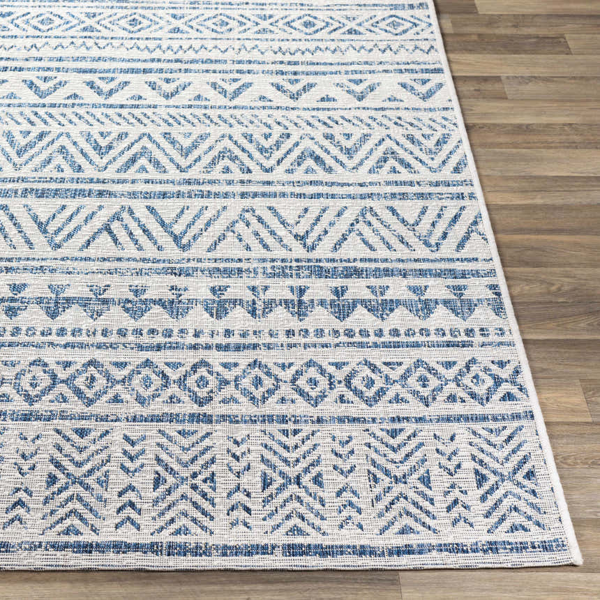 Close-up of the Novato Navy All Over Pattern Performance Rug showing blue and white geometric design. Front
