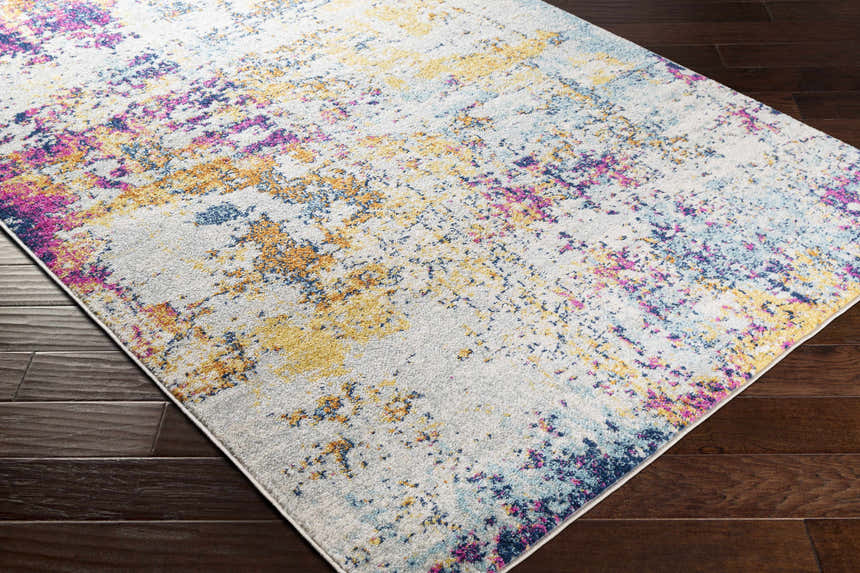 Close-up of Fowlmere Area Rug on dark wood floor. Contemporary style with aqua, pink, saffron, and gray colors. Corner