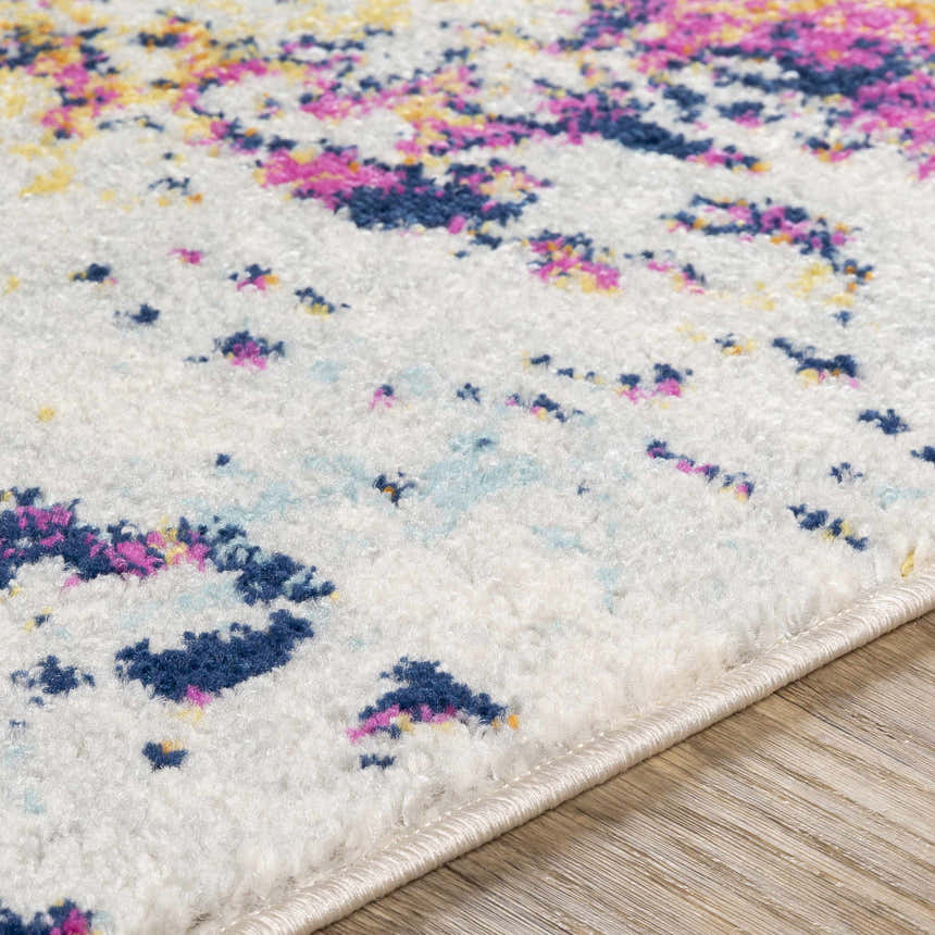 Close-up of the Fowlmere Area Rug showing its off-white base with colorful pink, blue, and yellow abstract pattern. Texture