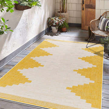 Patio scene with a yellow and beige geometric Djugun Yellow Outdoor Rug on a gray wood floor. Roomscene-Rectangle