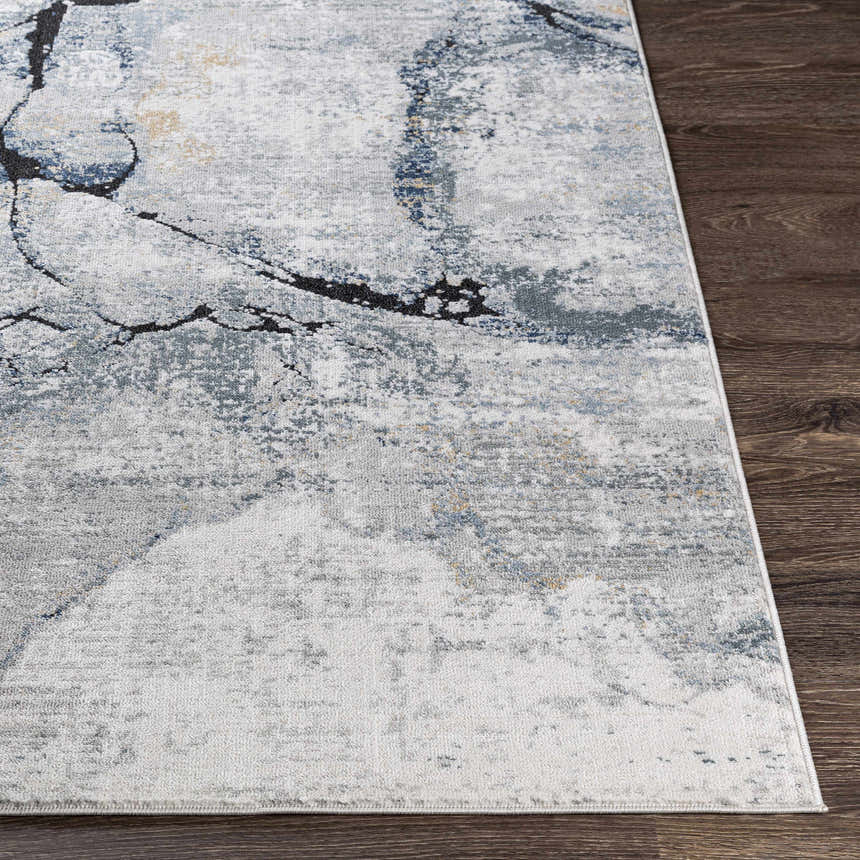 Close-up of the Fremantle Gray Marble Rug, showing cream, gray, gold, and blue abstract pattern and machine-woven texture. Front