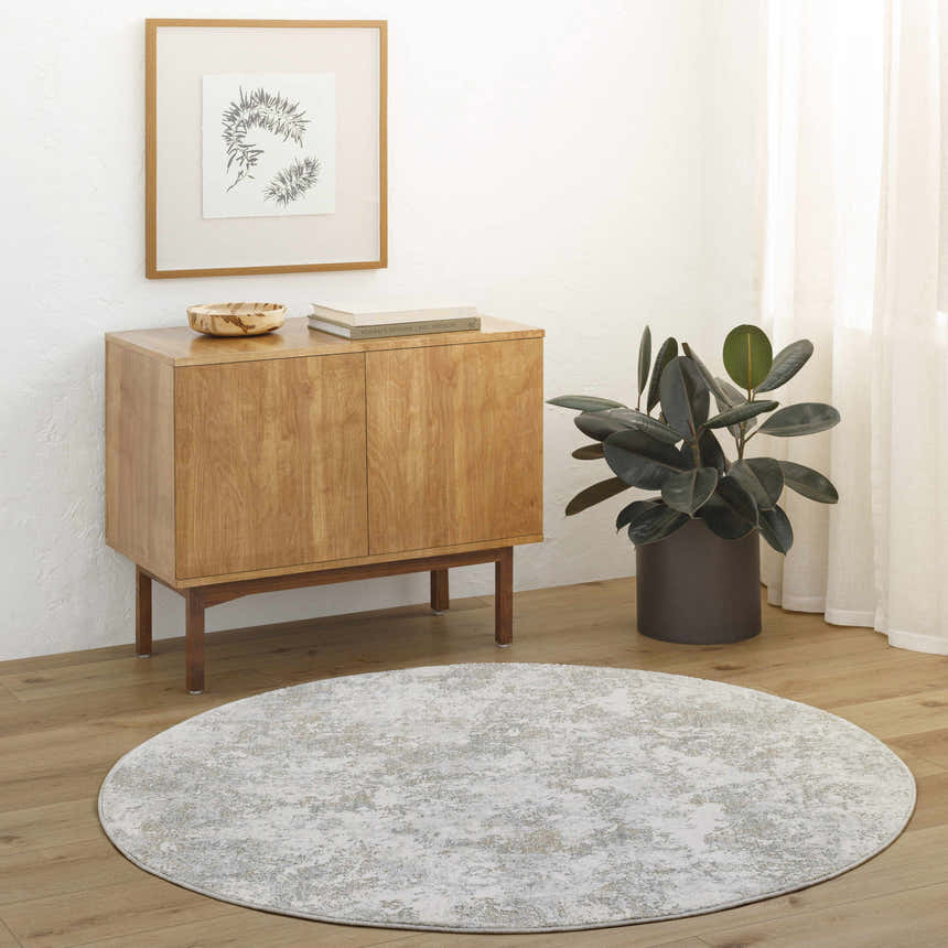 Minimalist room scene with round Ganit Thick Luxe Boutique Rug in beige, bone, and gray tones. Roomscene-Round