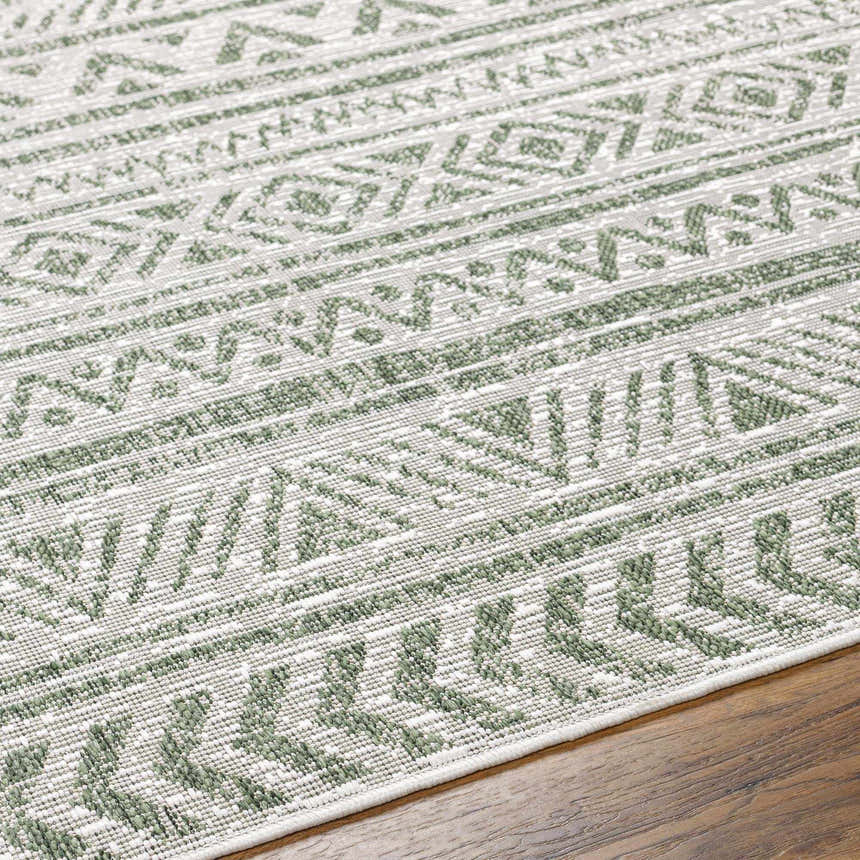 Close-up of the Novato Olive rug showing its geometric, all-over pattern in shades of olive green and gray. Texture