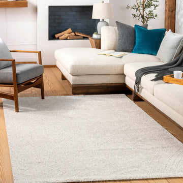 Living room scene with cream sectional sofa and light beige Eaglehawk Luxe Rug on hardwood floors. Roomscene-Rectangle