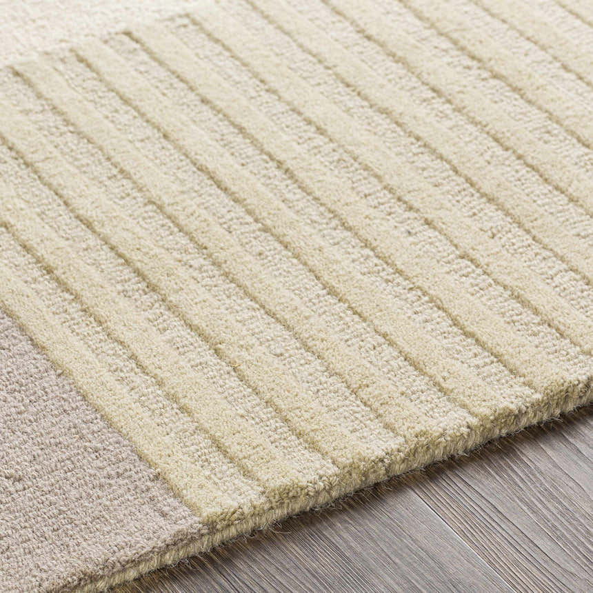 Close-up of the Glenmavis Area Rug, a hand-tufted wool rug with beige and light gray geometric stripes. Texture