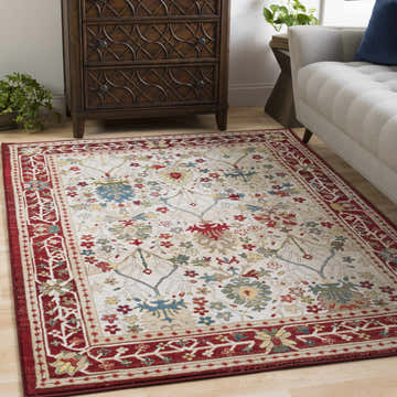 Living room scene with a Neola White/Red Damask Area Rug, gray sofa, and wood dresser. The rug adds a traditional, warm feel. Roomscene-Rectangle