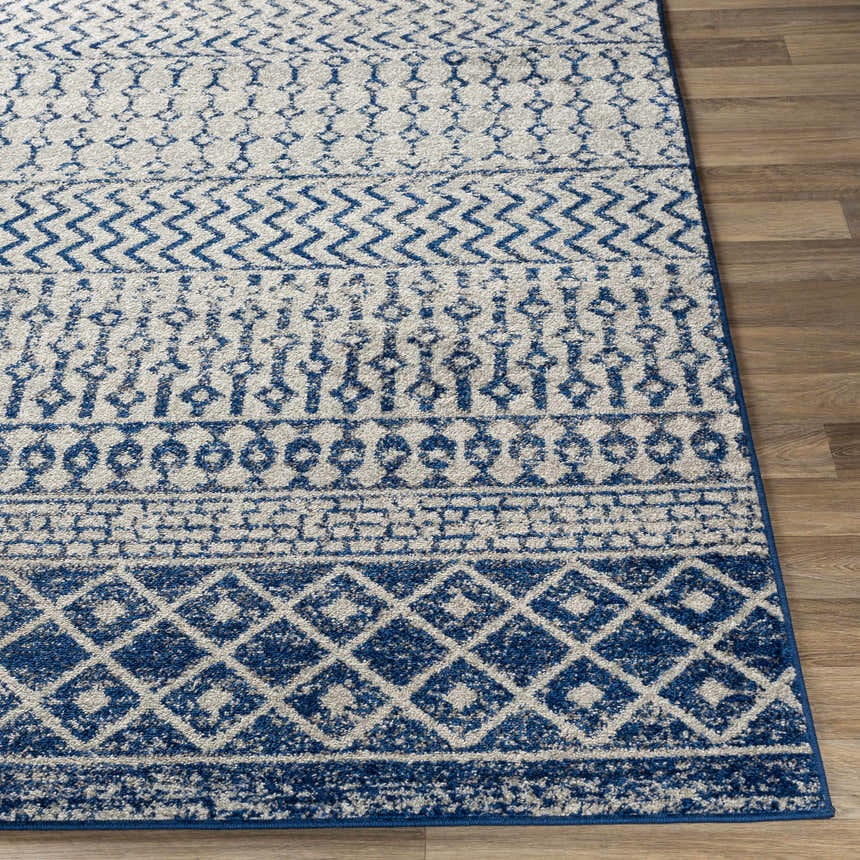 Close-up of the Constantin Blue Area Rug showing its bohemian-inspired blue and white geometric pattern and soft texture. Front