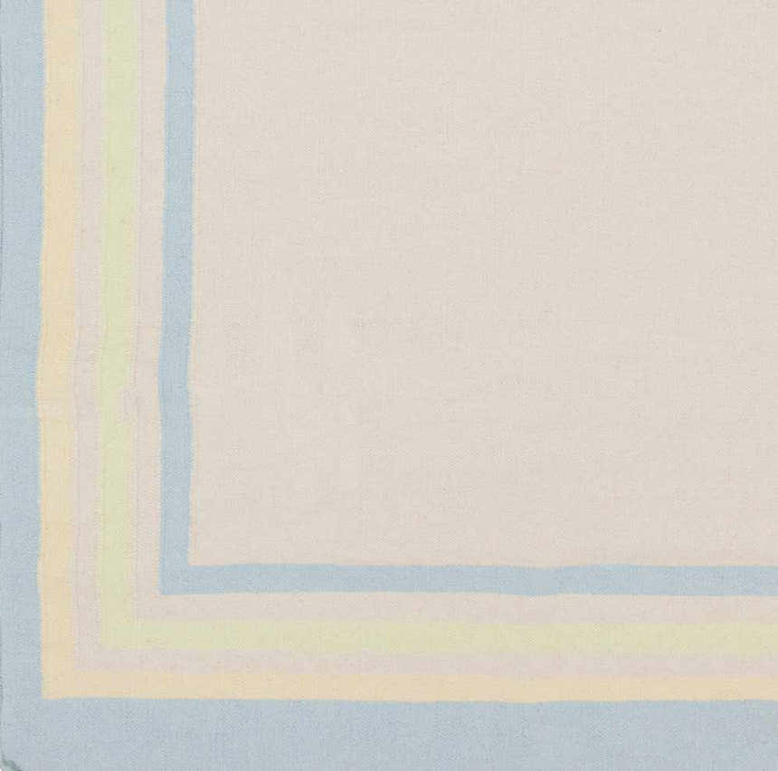 Close-up of the hand-woven Hackberry Area Rug. Ivory rug with light blue, light olive, and yellow border stripes. Swatch