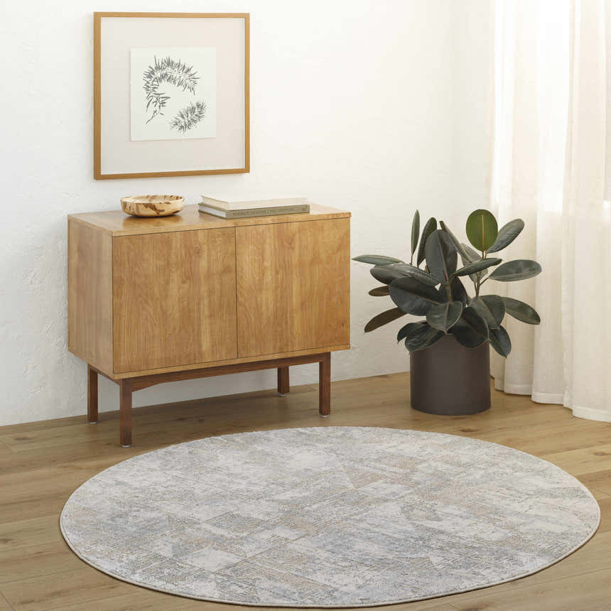 Living room scene with round Halia Thick Luxe Boutique Rug in cloud gray and brown tones. Roomscene-Round
