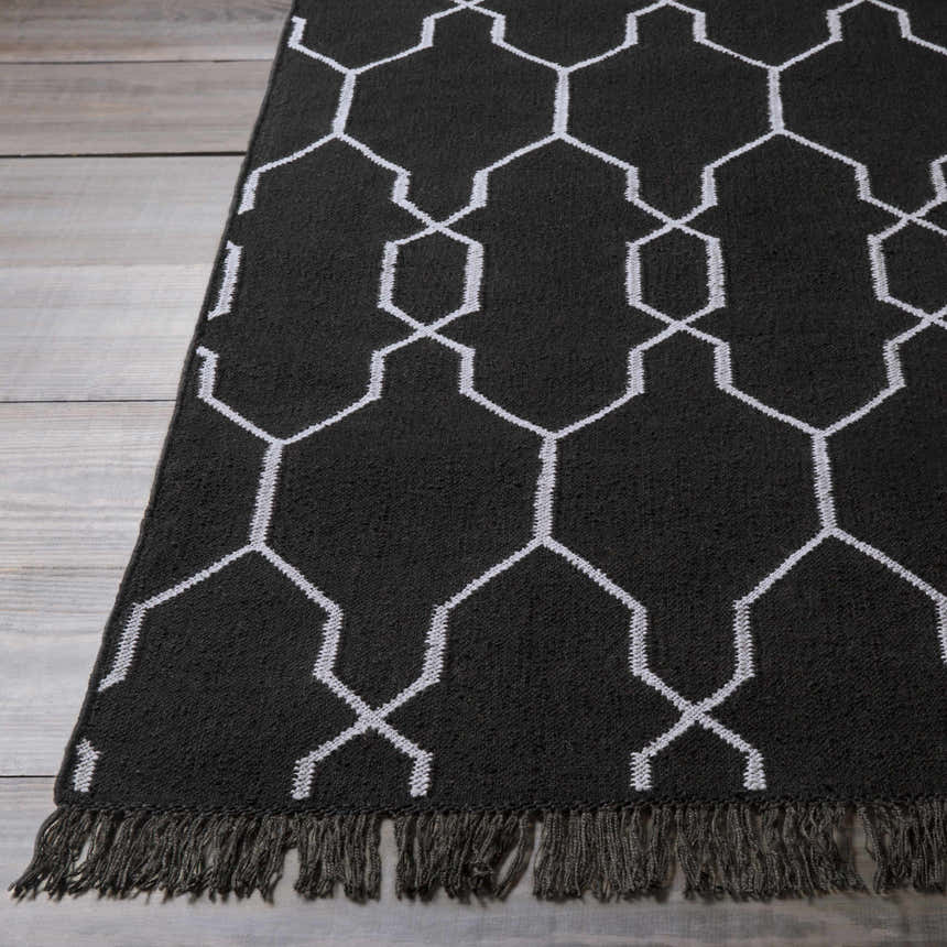 Close-up of the black and white Hawthorne Indoor & Outdoor Rug, showcasing its geometric pattern and fringe detail. Front