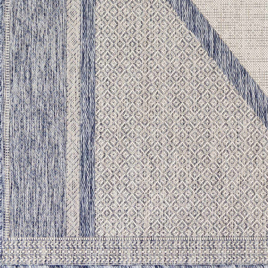 Close-up of Hazar Gray Area Rug showing geometric pattern, dark gray and natural gray colors, and woven texture. Swatch