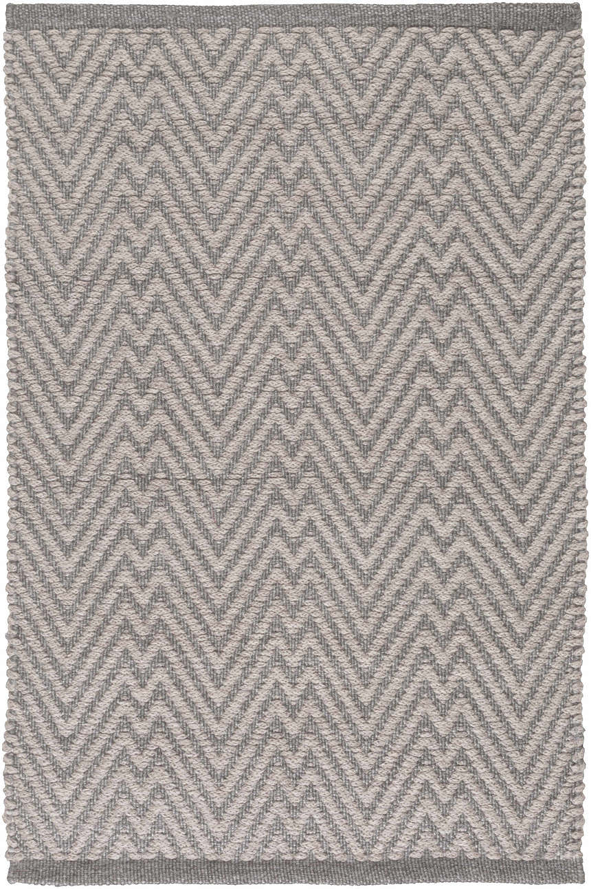 Close-up of the Herlong Charcoal Herringbone Rug, featuring a textured, hand-woven zig-zag pattern in charcoal and light brown. Design-Rectangle-23