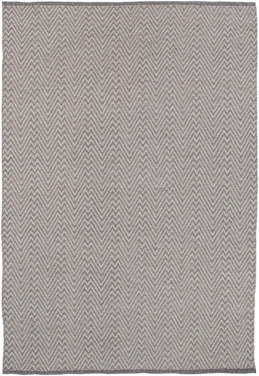 Close-up of the Herlong Charcoal Herringbone Rug. Hand-woven rug with a charcoal and light brown chevron pattern. Design-Rectangle-576