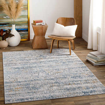 Living room scene with blue and mustard Hughesdale Distorted Lines Luxe Area Rug, wood chair, side table, and neutral decor. Roomscene-Rectangle