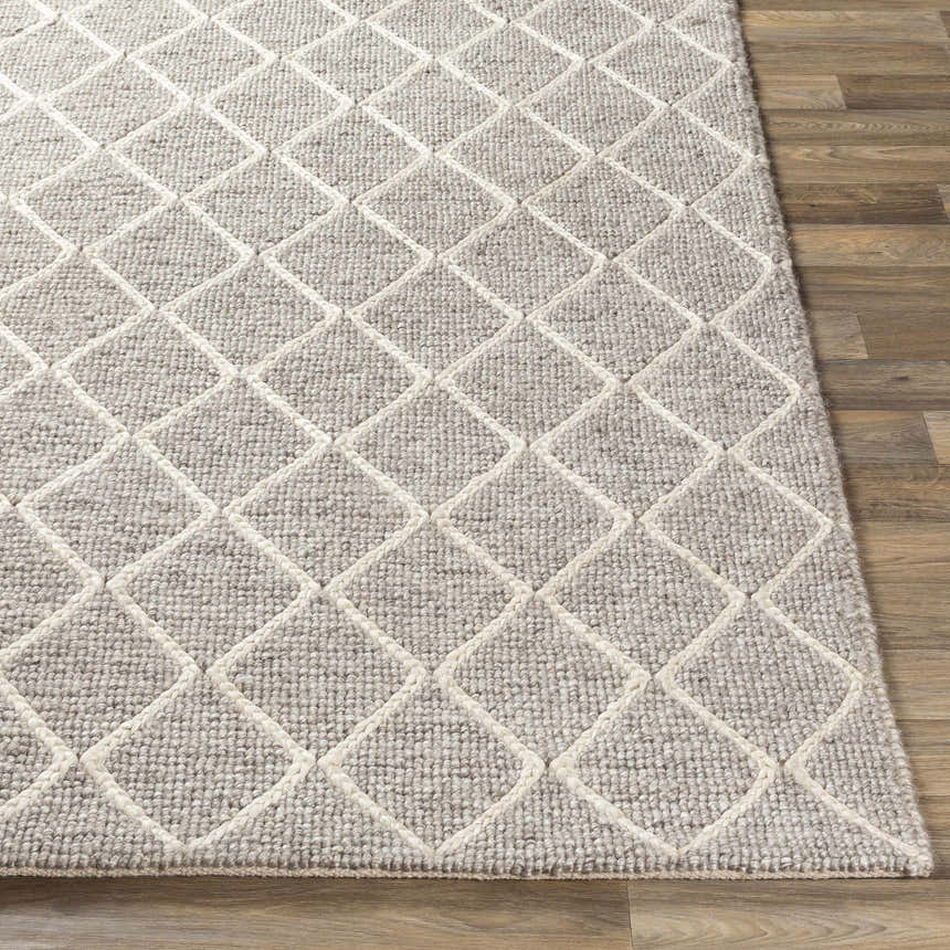 Close-up of the Hindley Area Rug, a hand-woven rug with a cream diamond pattern on a gray wool and viscose blend. Front