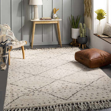 Living room scene with a cream Halling Area Rug, gray walls, wood accents, and a bohemian, cozy feel. Roomscene-Rectangle