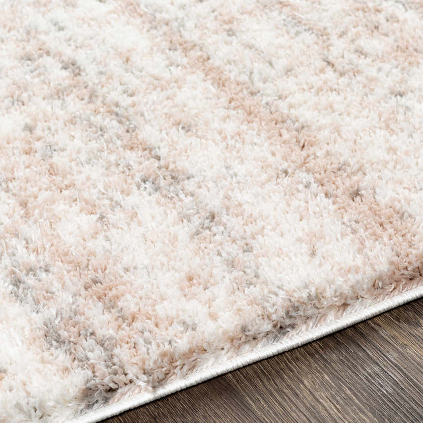 Close-up of the plush Hammond Dusty Pink Rug showing cream, dusty pink, and gray tones and soft shag texture. Texture