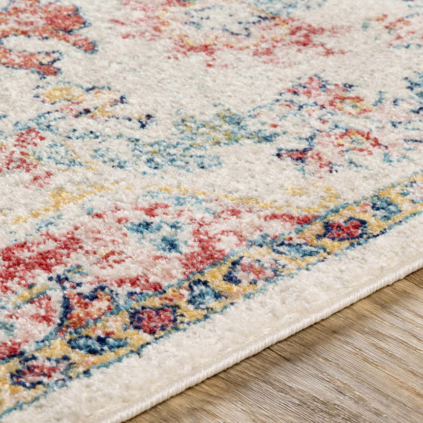 Close-up of the Hemingbrough Red&White Medallion Rug. Features a bohemian-style design with red, blue, and saffron colors. Texture