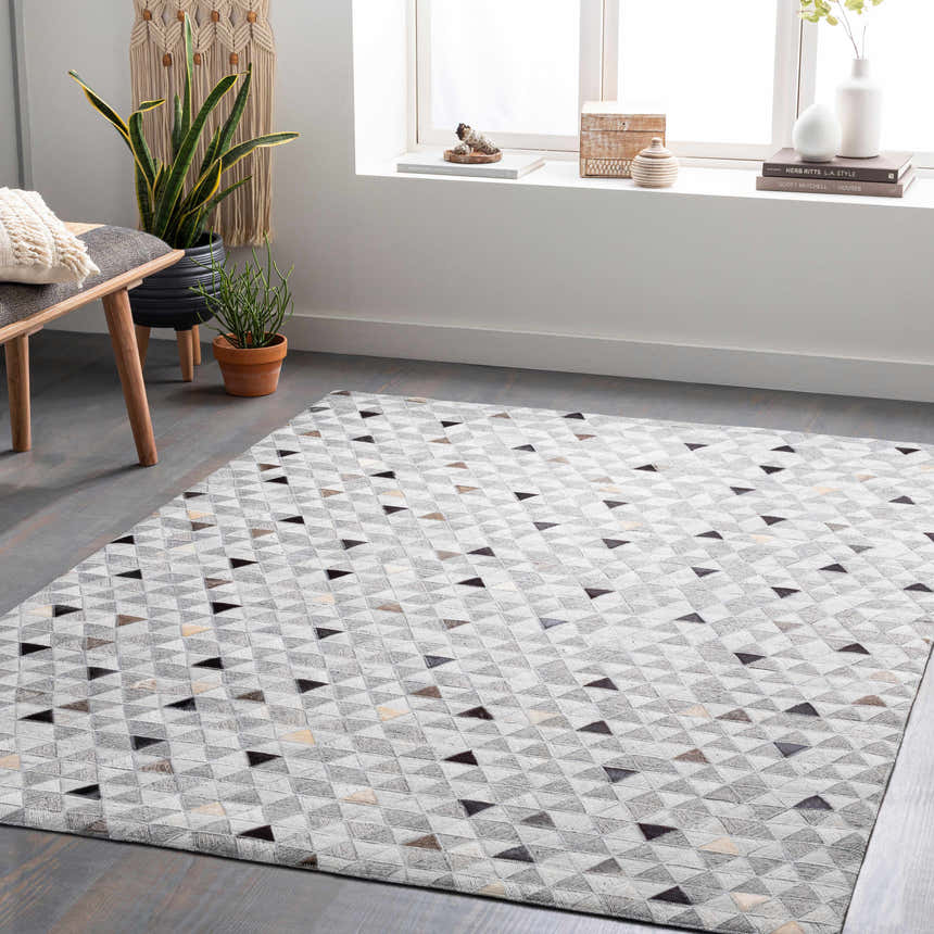 Scandinavian-style room with a gray floor and Horasan Area Carpet featuring black, gray, and brown triangles. Roomscene-Rectangle