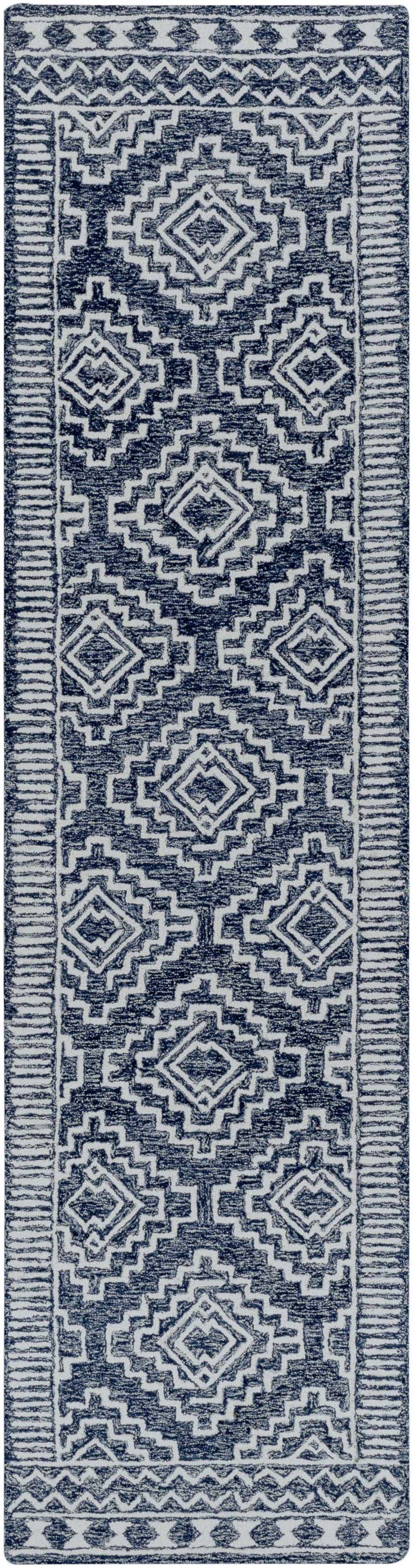 Close-up of the Horton Modern Wool Rug; navy and beige geometric pattern, hand-tufted texture. Bohemian style. Design-Runner-2610