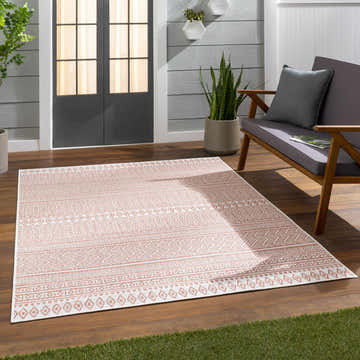 Outdoor patio scene with a beige and bone Howie Area Rug, wood floors, and a gray loveseat. Roomscene-Rectangle