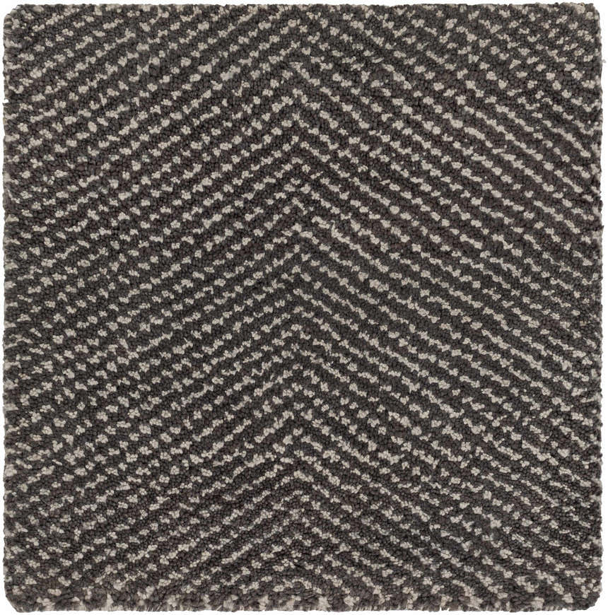 Close-up of the Hoyt Carpet, a hand-knotted rug with a charcoal and off white chevron pattern. Contemporary style. Swatch