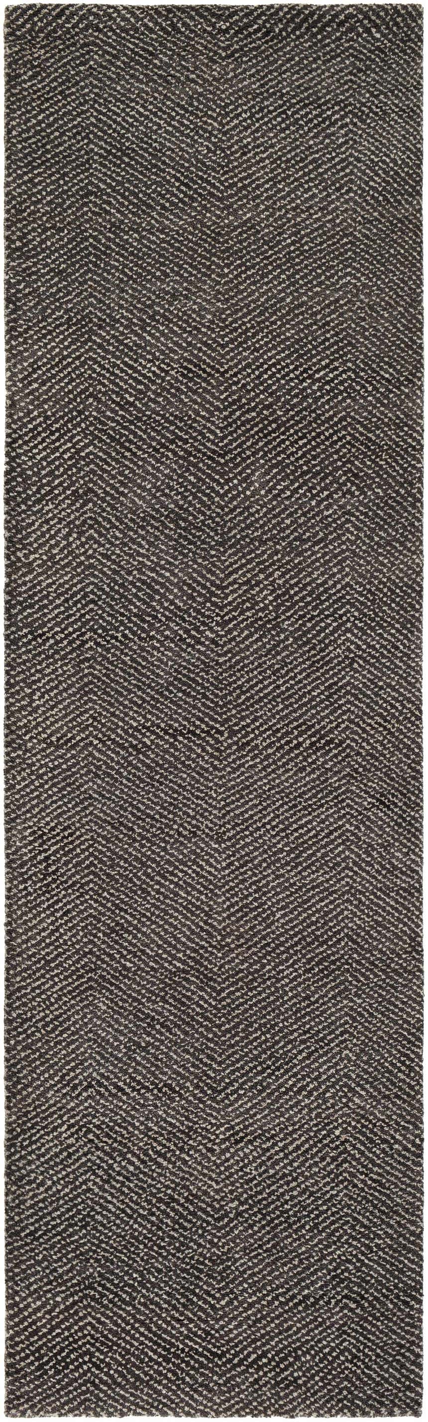 Close-up of the Hoyt Carpet, a hand-knotted rug with a contemporary charcoal and off white chevron design. Design-Runner-268