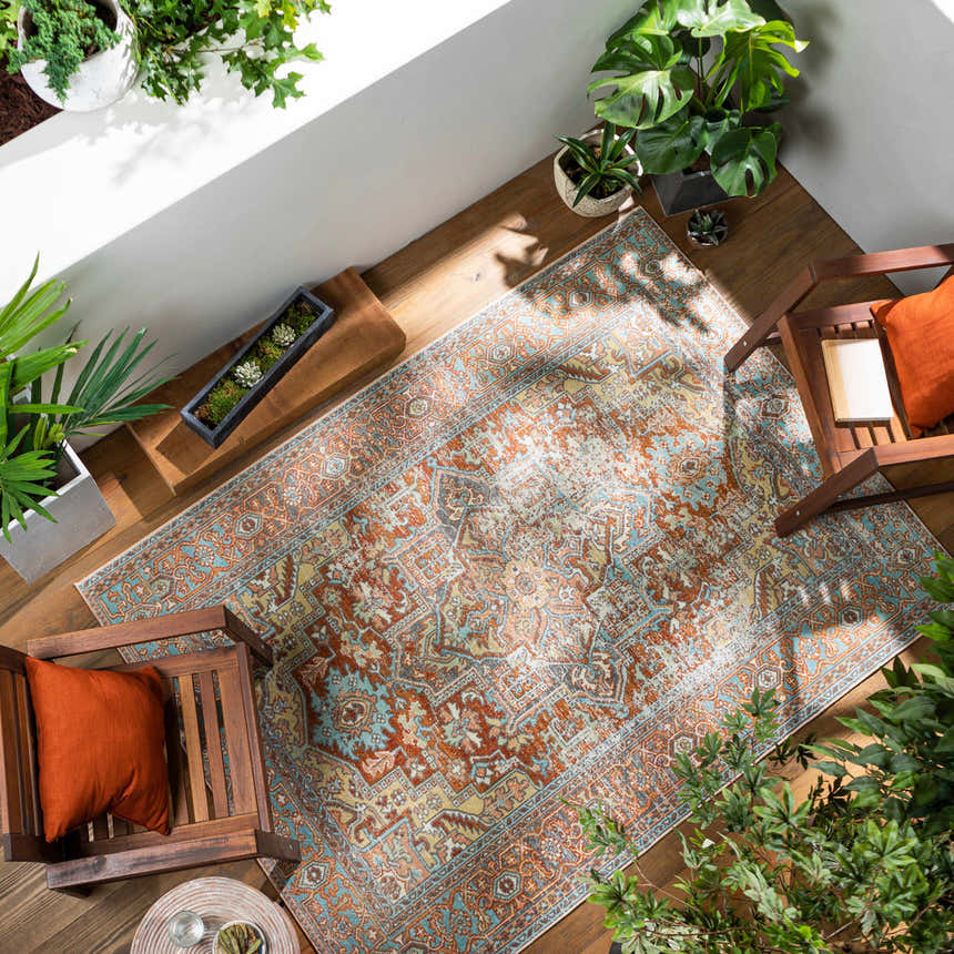 Outdoor patio with wood chairs and the brick red Hardwick Performance Rug. Roomscene-Rectangle