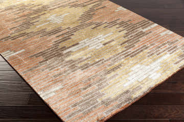Close-up of the Hundon Viscose Area Carpet. Contemporary design with black, brick red, brown, and taupe hues. Hand-knotted texture. Corner