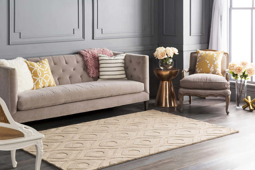 Living room scene with a tan Hundred Area Rug, sofa, accent chair, and gray walls. Roomscene-Rectangle