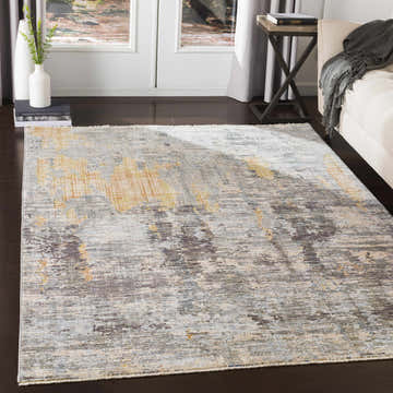 Living room scene with a Hustontown Carved Statement Rug in shades of blue, charcoal, gray, and saffron. Roomscene-Rectangle