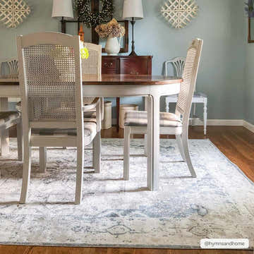 Light blue dining room with a round table on a Hera Ivory Boutique Washable Rug. Roomscene-Rectangle