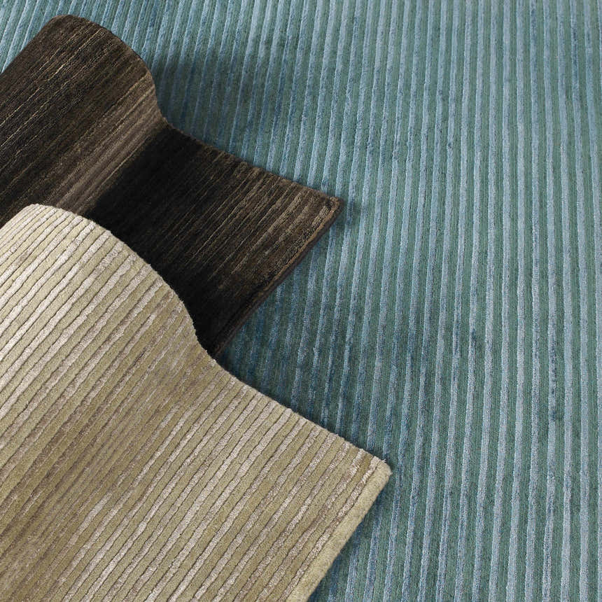 Close up of Sanatoga Area Rug showing texture and colors: teal, brown, and beige stripes. Hand knotted wool and viscose rug. Styleshot