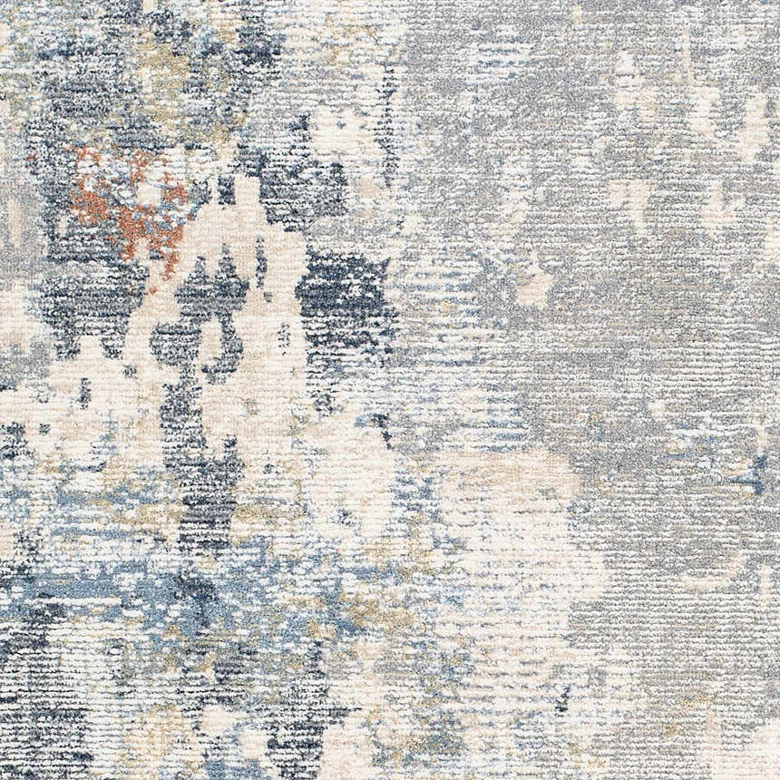 Close-up of the Iryna Area Rug showing its contemporary charcoal, gray, and brown abstract pattern and soft polyester texture. Swatch