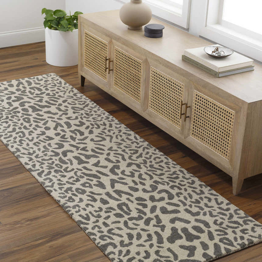 Entryway scene with Iseul Leopard Print Area Rug runner in gray and taupe, paired with a wood console table and hardwood floors. Roomscene-Runner
