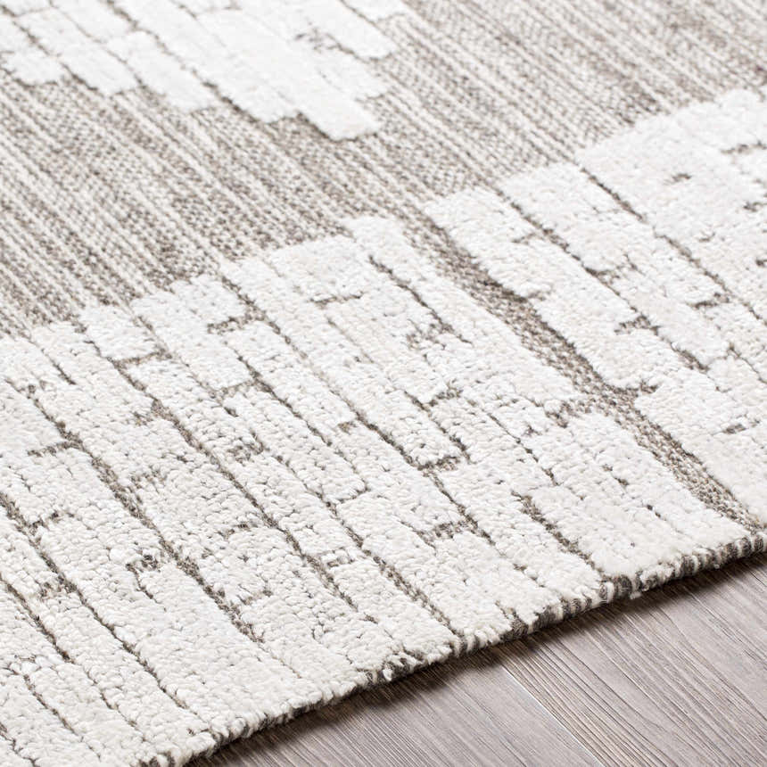 Close-up of the hand woven Junction Carpet. Brown and light beige wool rug with a farmhouse style pattern. Texture