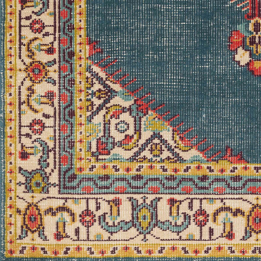 Close-up of the hand-knotted Kaser Carpet. Farmhouse style rug with dark plum, beige, green, mustard, olive, red, and teal colors. Swatch