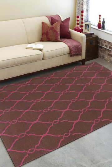 Living room scene with a brown and magenta Keansburg Wool Area Rug, cream sofa, and brick accent wall. Roomscene-Rectangle
