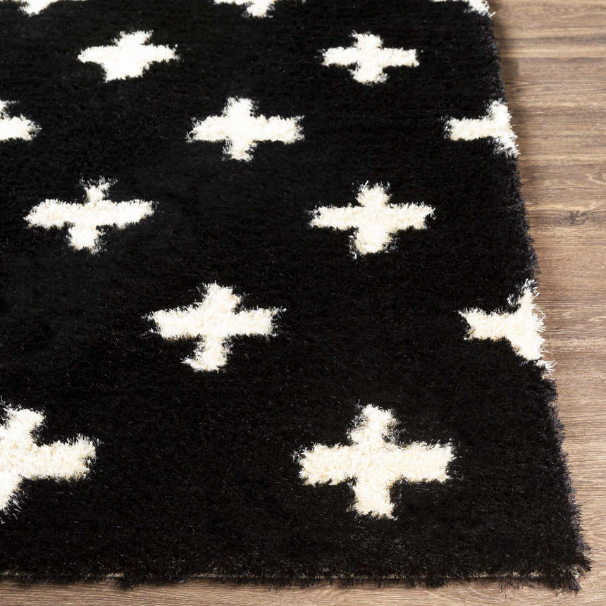 Close-up of the black and ivory Keperra Area Rug. Shag rug with plus sign pattern. Hand-tufted polyester texture. Front