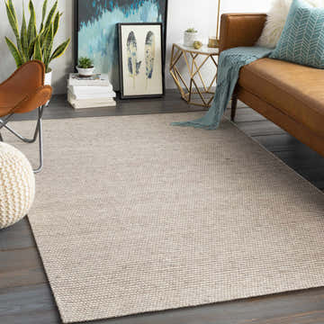 Contemporary living room with a light gray Kerman Carpet, brown leather sofa, and modern decor. Roomscene-Rectangle