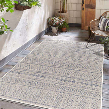 Bohemian patio scene with Novato Gray All Over Pattern Performance Rug, wicker chair, wood floors, and potted plants. Roomscene-Rectangle