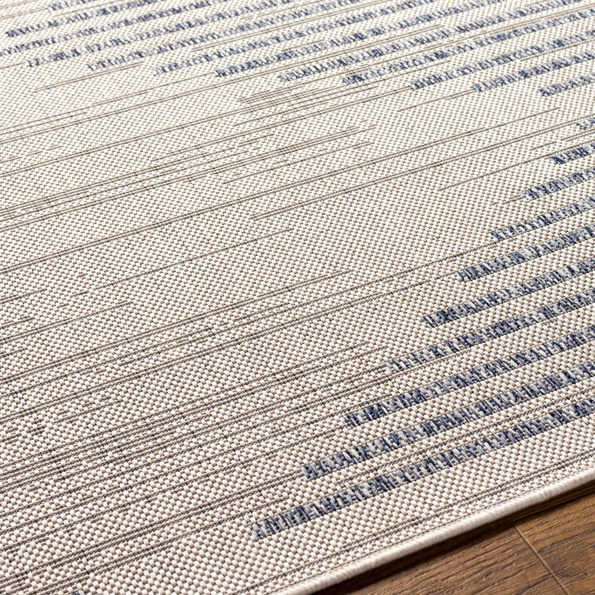 Close-up of the Khandallah Area Rug featuring a cream base with geometric dark gray and navy stripes. Texture