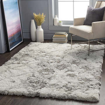 Living room scene with a gray Kilgetty Gray Cloudy Shag Rug, beige chair, and gray walls. Contemporary style. Roomscene-Rectangle