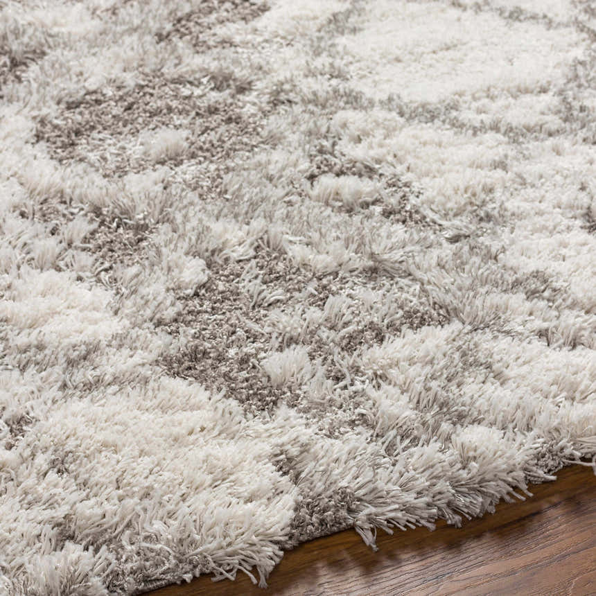 Close-up of the Kilgetty Gray Cloudy Shag Rug. Features a soft, fluffy texture and cloudy pattern in gray and off-white tones. Texture
