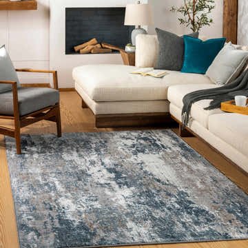 Living room scene with a gray and blue Kipkelion Area Rug, cream couch, fireplace, and wood floors. Roomscene-Rectangle