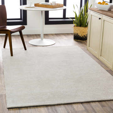 Light gray Keller Area Rug in a bright dining room with wood floors and modern white table. Roomscene-Rectangle