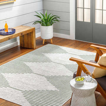 Farmhouse sunroom with Stephan Green Outdoor Rug, wood bench, chair, and white accent table. Roomscene-Rectangle